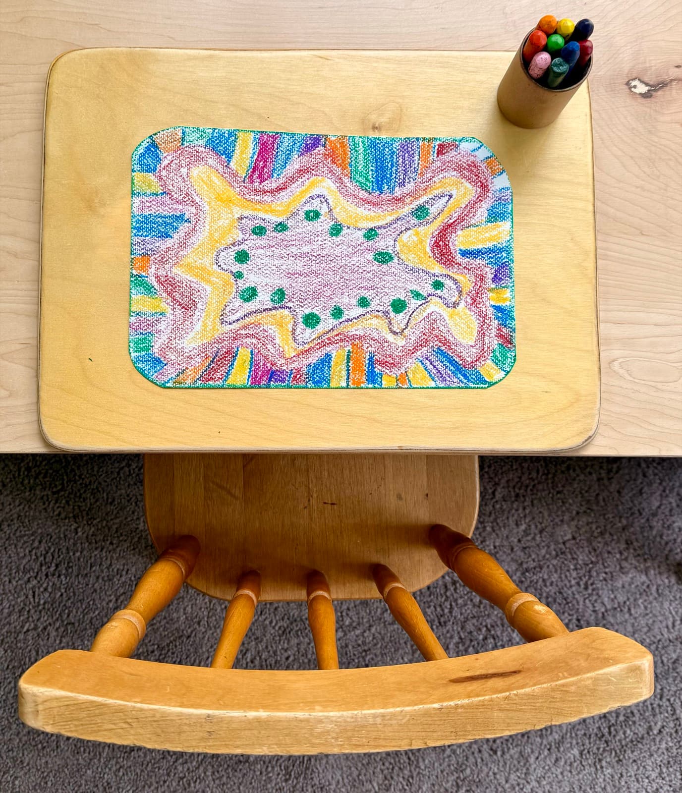 A colorful crayon mandala drawing made in class
